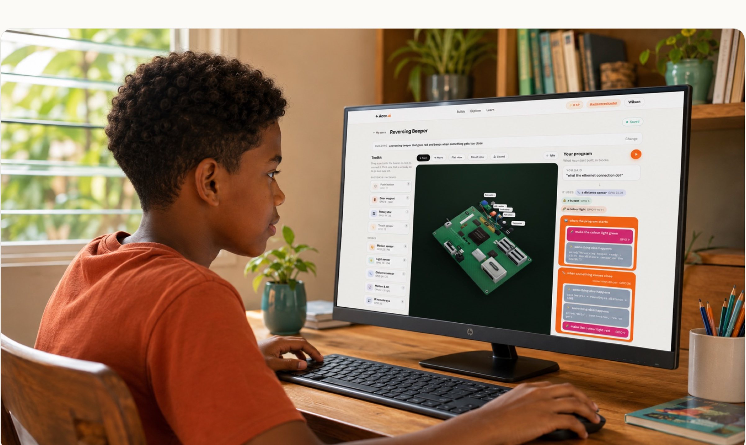 A child at a monitor showing the Pi Lab: the parts, the board and the program on one screen